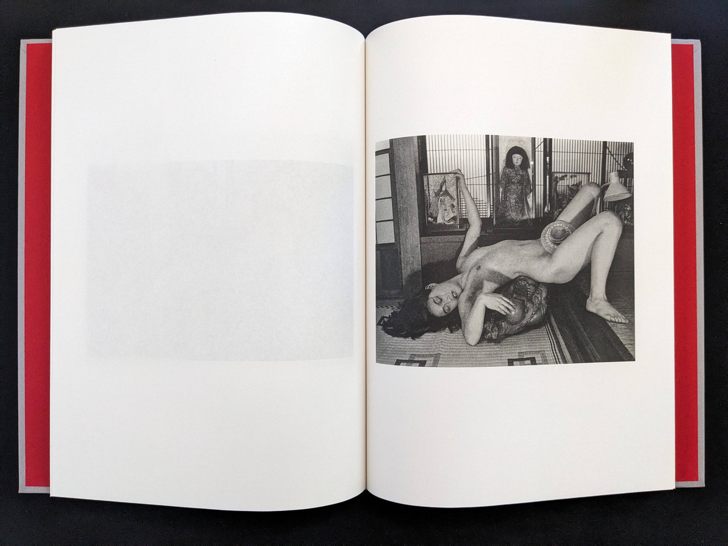Open spread with a black-and-white nude figure posed in a traditional interior on the right page in Eros Lost.