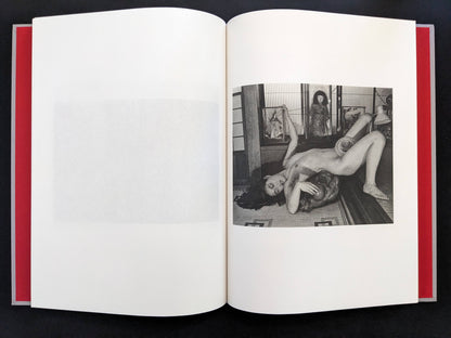 Open spread with a black-and-white nude figure posed in a traditional interior on the right page in Eros Lost.