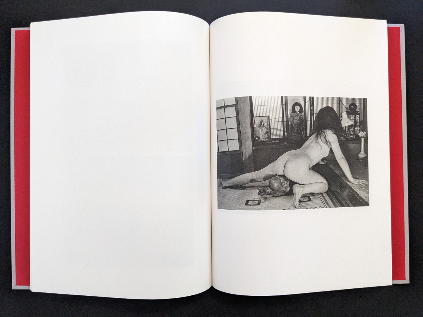 Open spread with a black-and-white nude figure in a Japanese interior on the right page in Eros Lost.