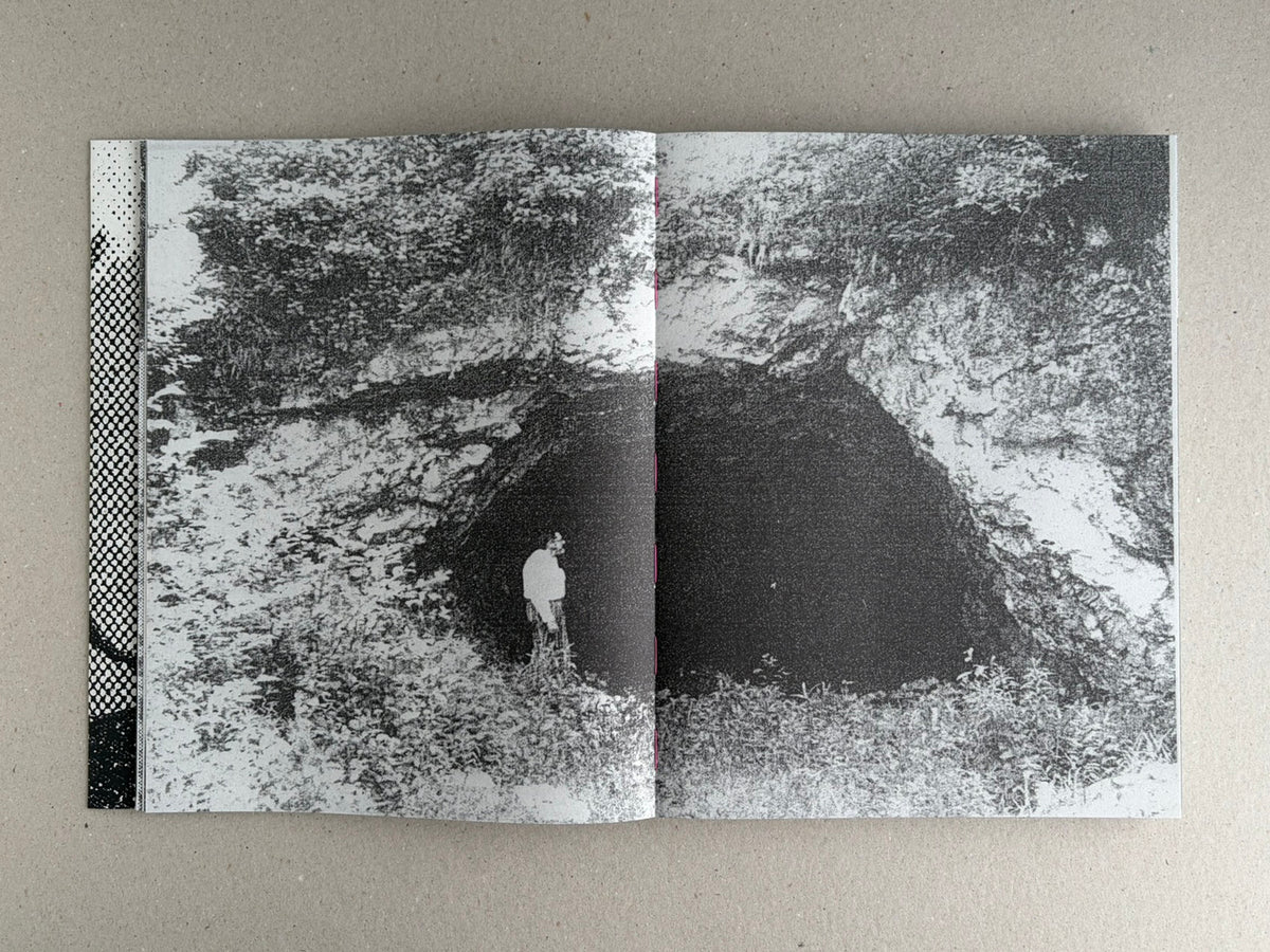 Open Fishworm spread in black and white, showing a grainy landscape image across two pages with a small figure near the center fold.