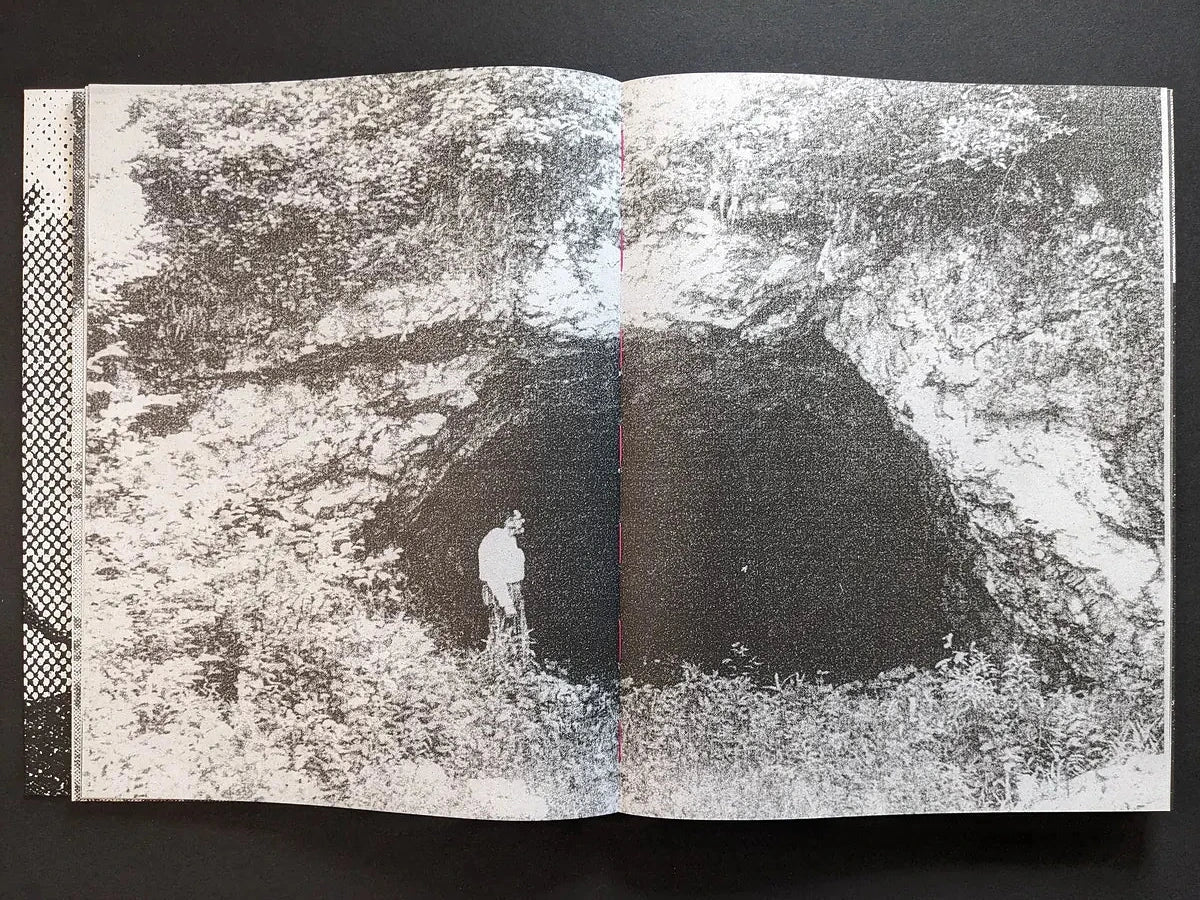 Interior spread from Fishworm showing a dark forest pit surrounded by rough vegetation in heavy Xerox texture.