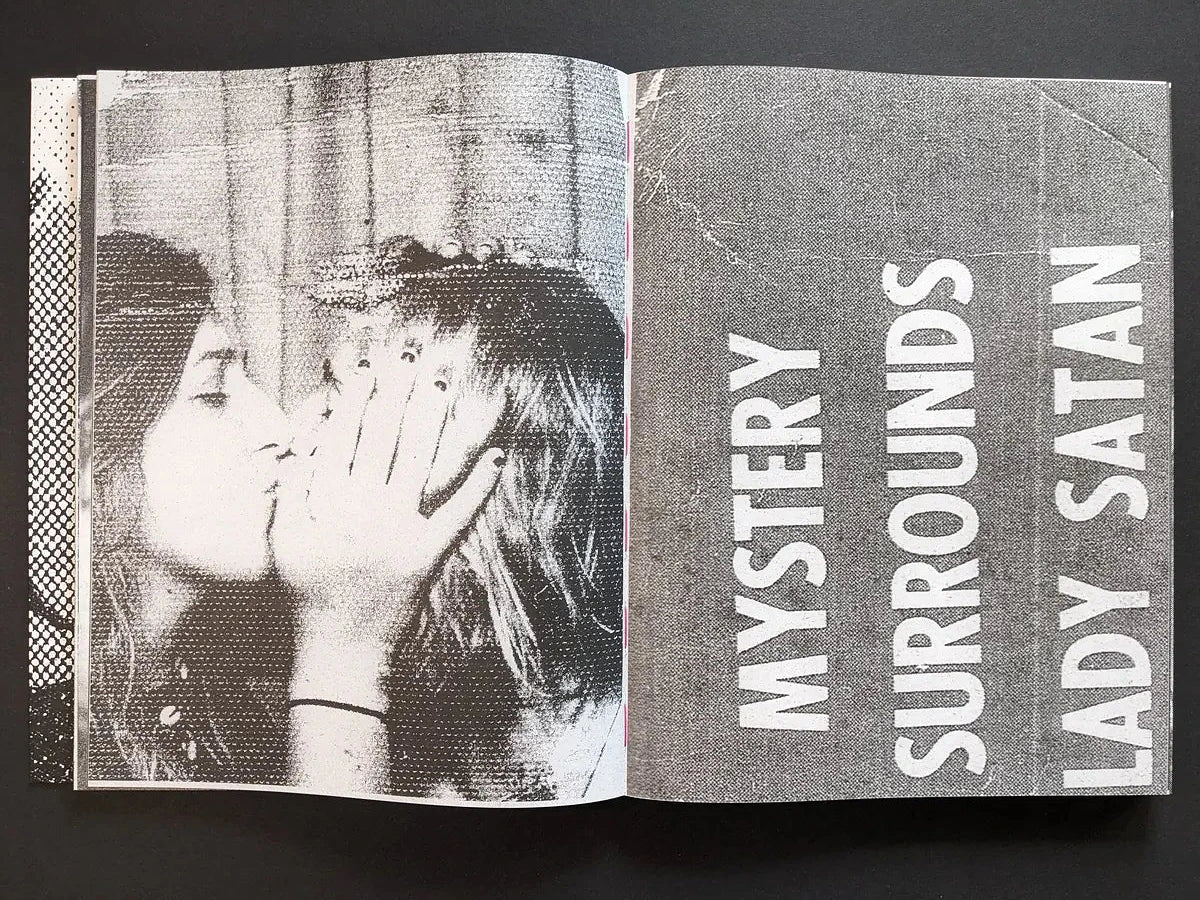 Interior spread from Fishworm pairing the headline “Mystery Surrounds Lady Satan” with a close-up of kissing women.