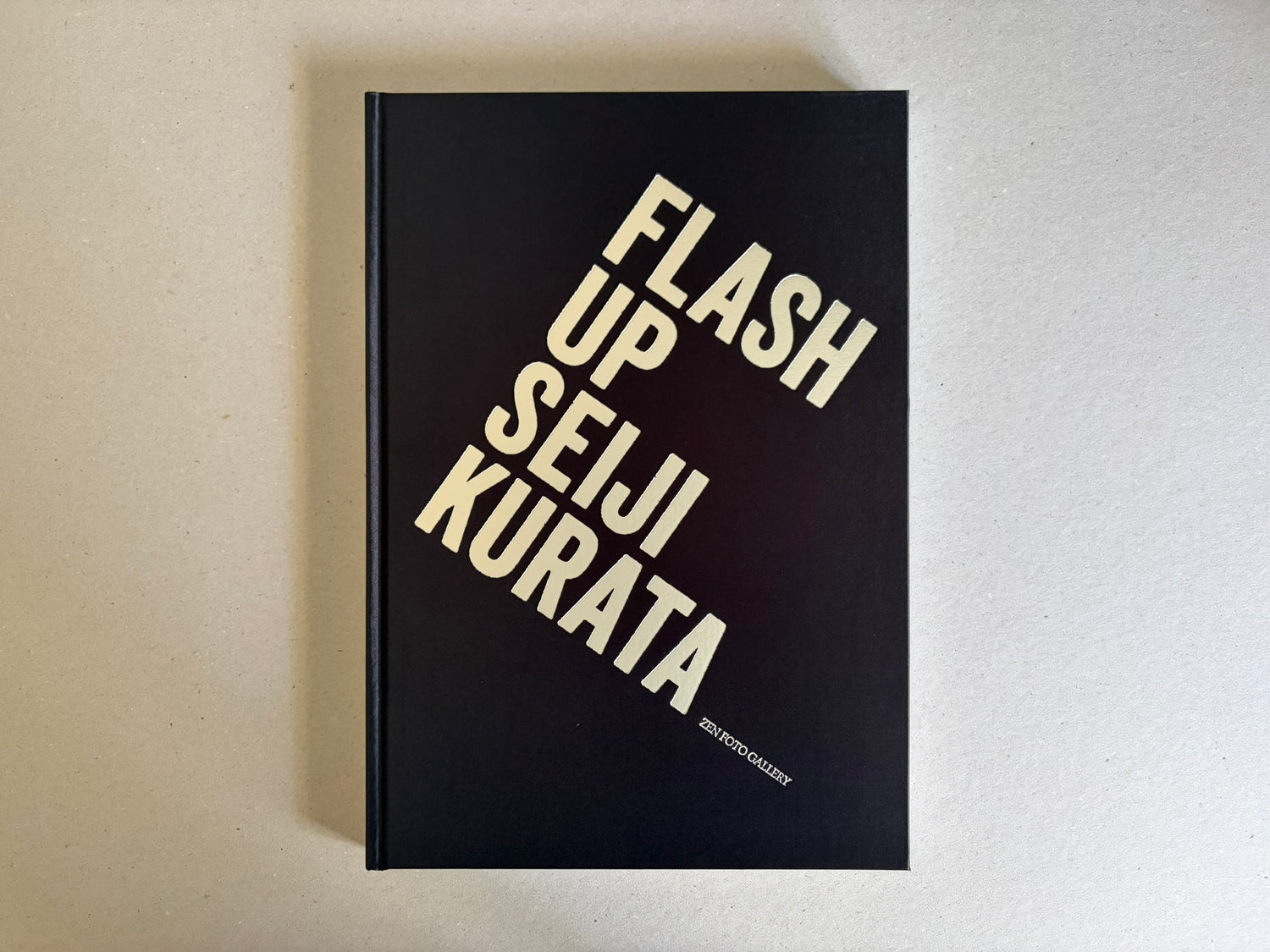 Flash Up by Seiji Kurata, front cover with black background and diagonal title text