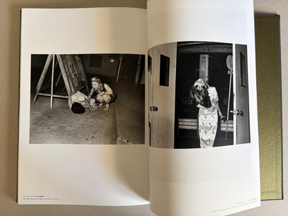 Flash Up by Seiji Kurata, open spread with two black-and-white photographs of a fallen man and a street scene