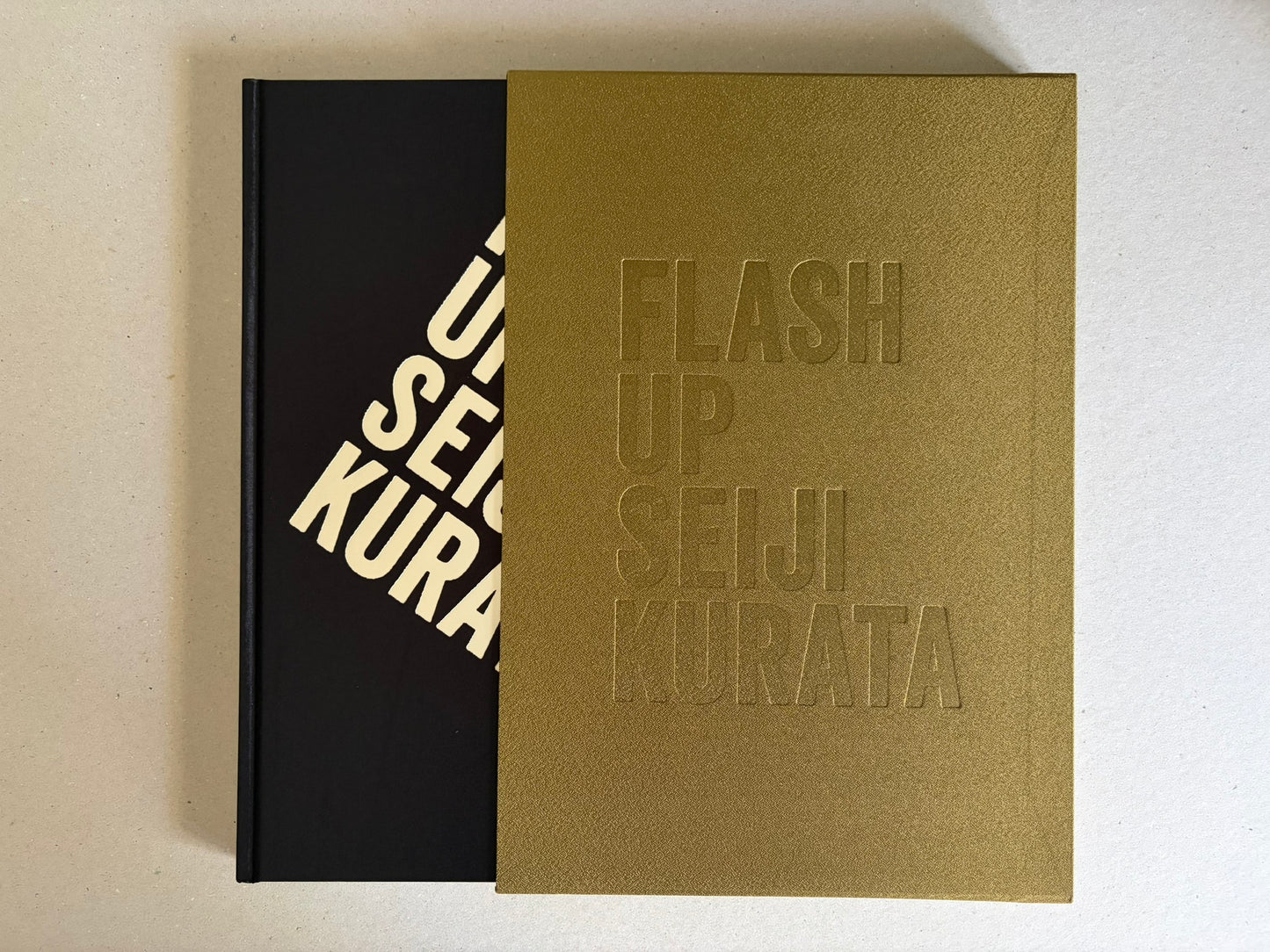Flash Up by Seiji Kurata, book with gold slipcase partially covering the cover