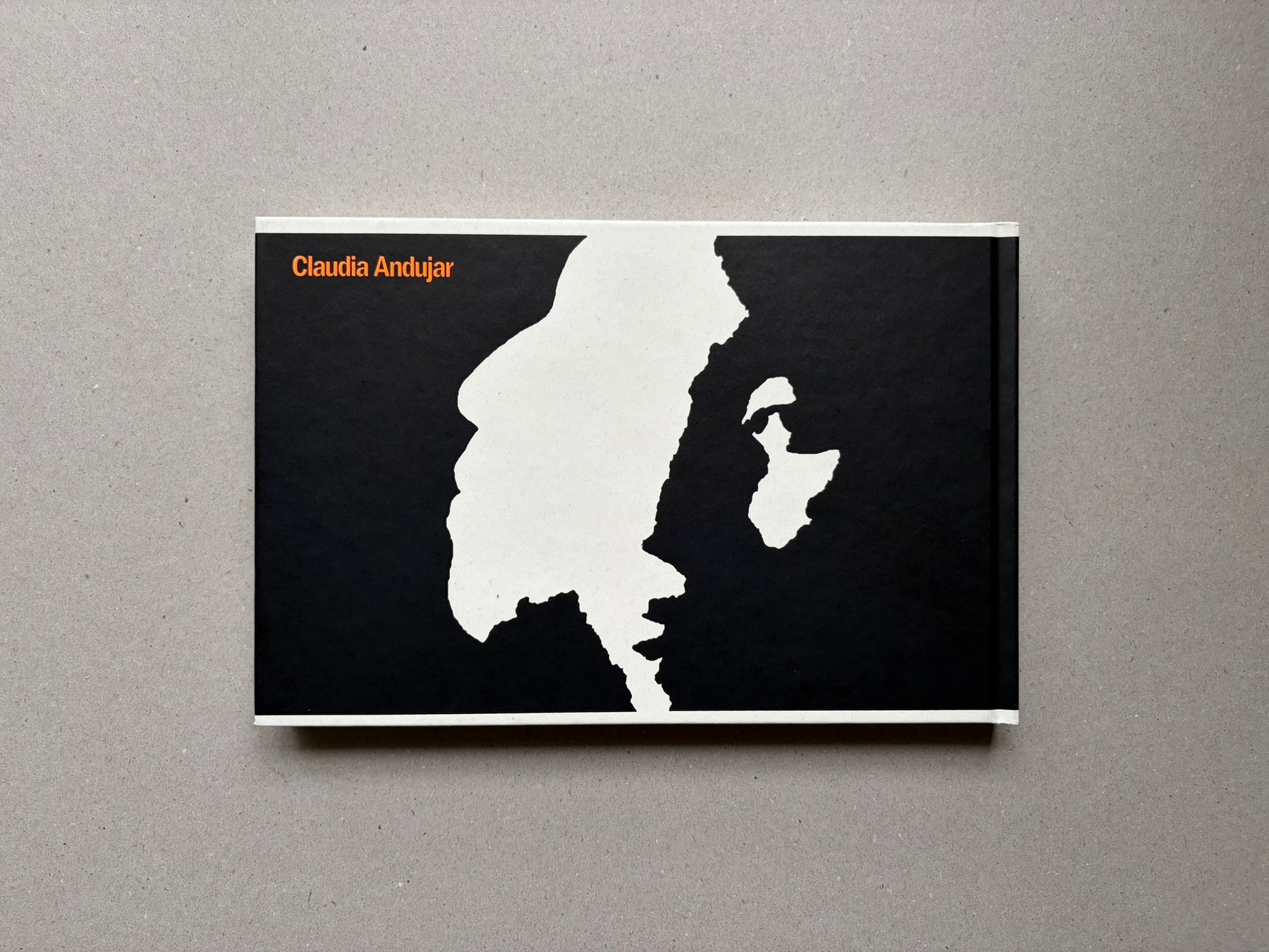 Genocídio do Yanomami by Claudia Andujar, back cover with black-and-white graphic design and orange author name