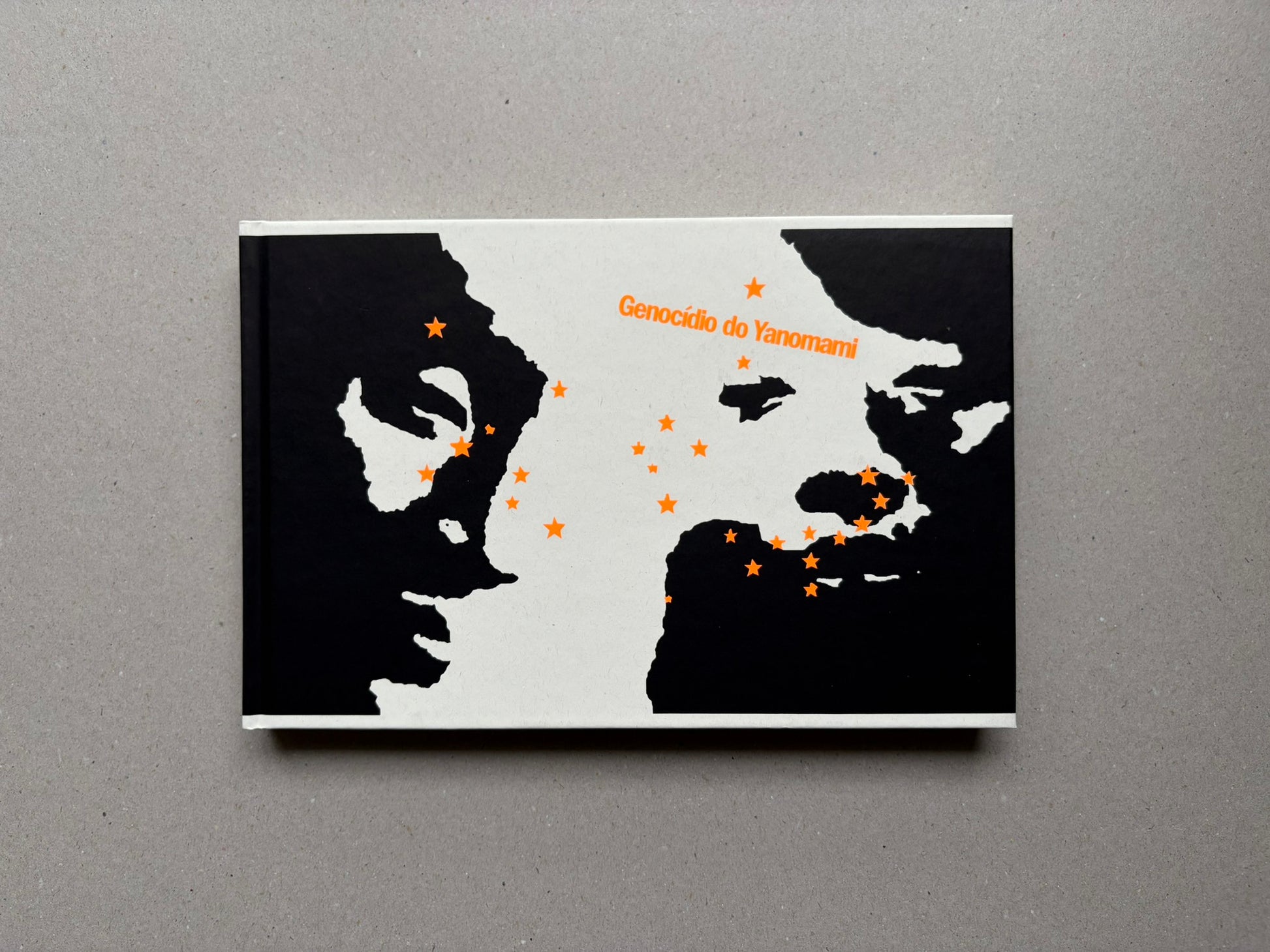 Genocídio do Yanomami by Claudia Andujar, front cover with black-and-white graphic design and orange title text