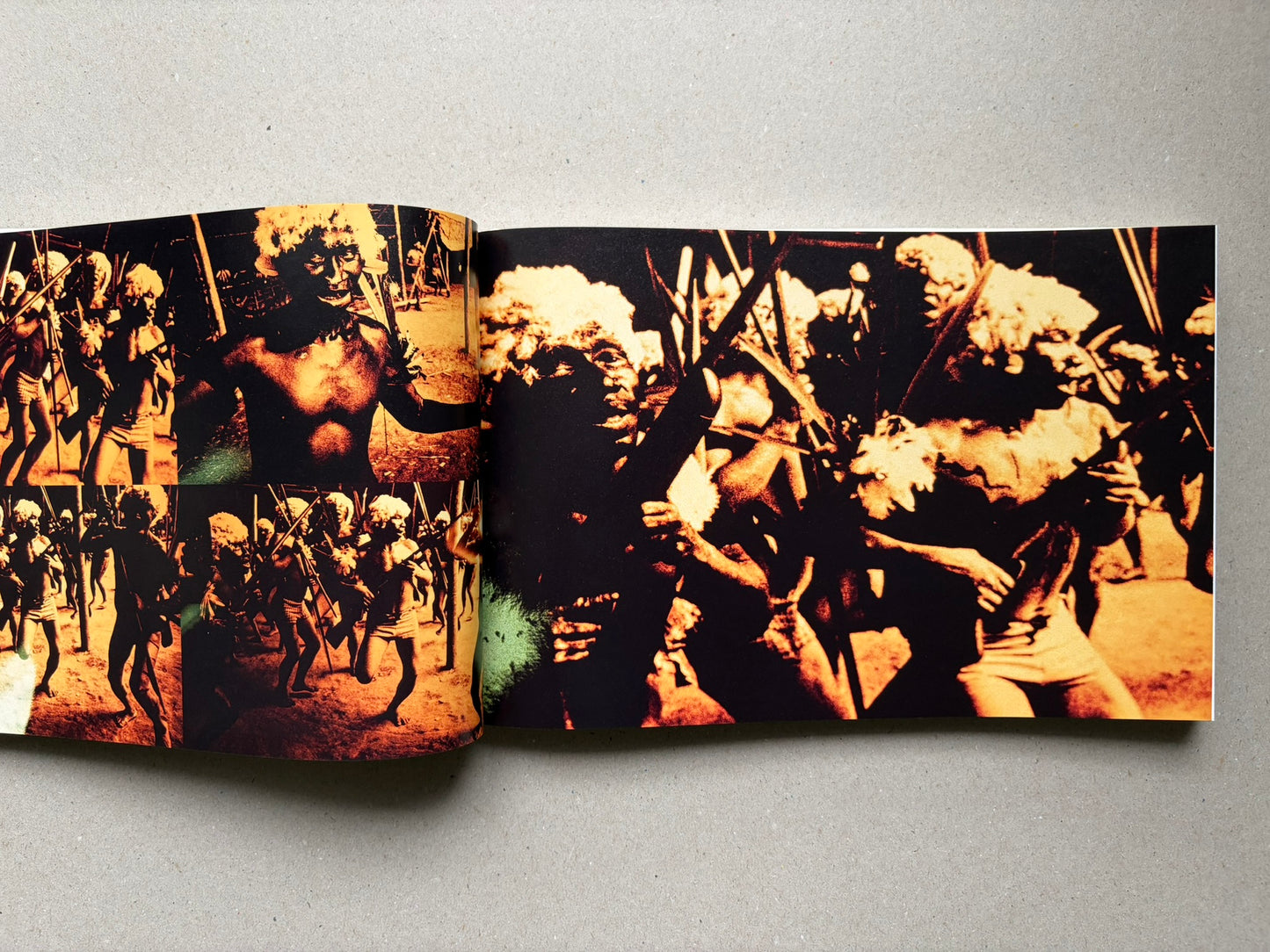 Genocídio do Yanomami by Claudia Andujar, open spread with orange-toned photographs of Yanomami figures