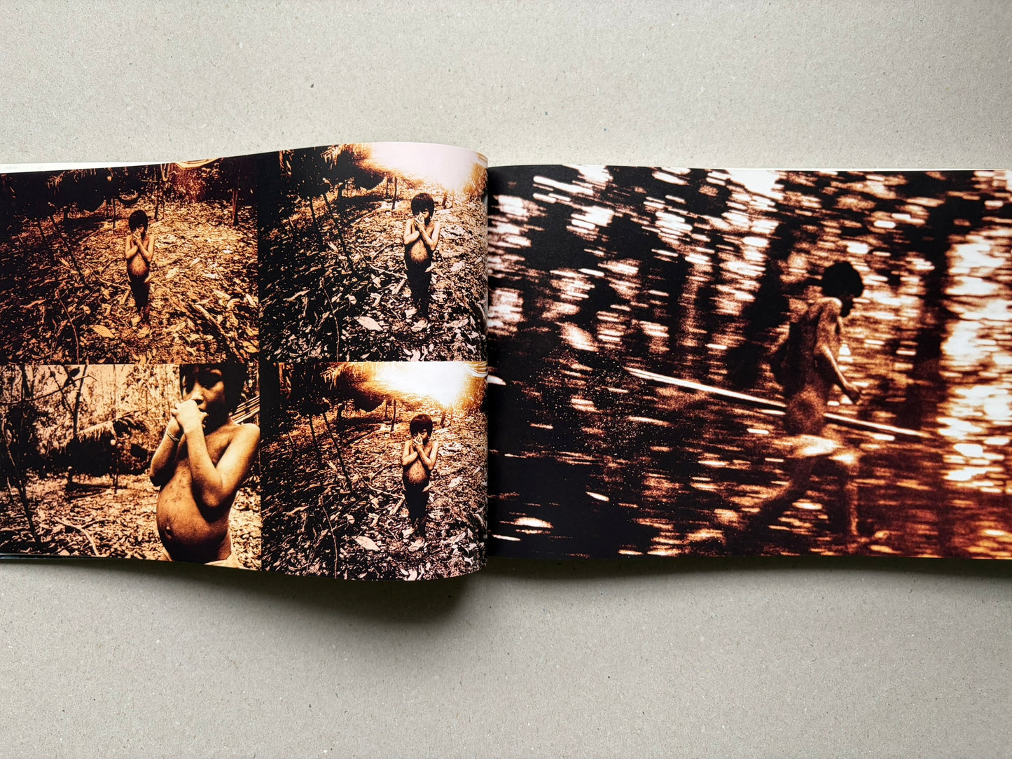 Genocídio do Yanomami by Claudia Andujar, open spread with multiple portraits and blurred forest imagery
