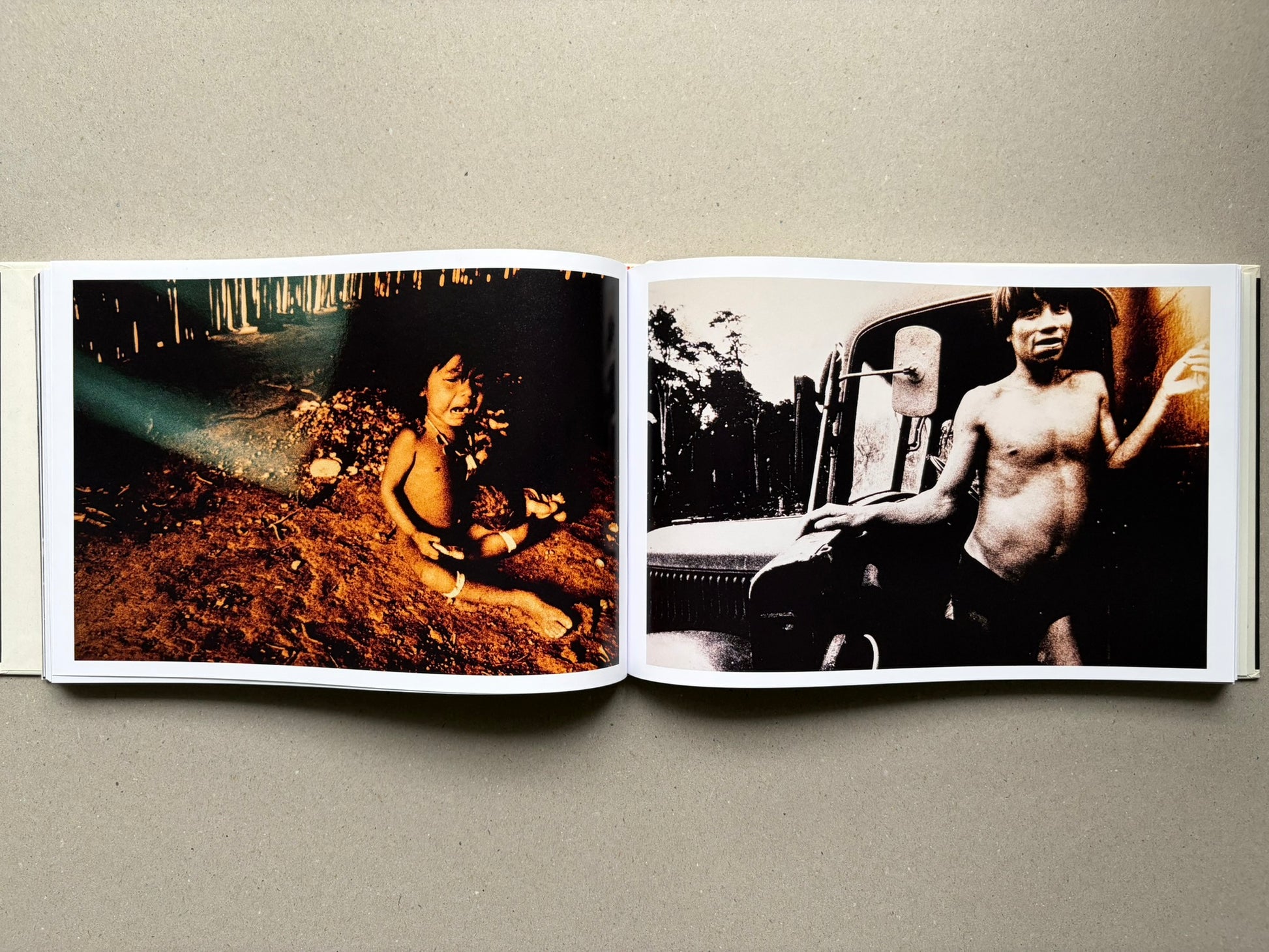 Genocídio do Yanomami by Claudia Andujar, open spread with a child on the left and a standing figure on the right