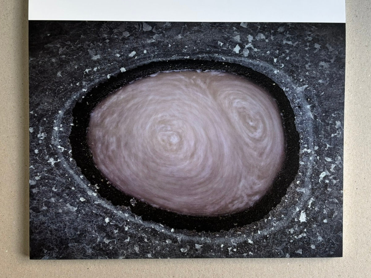 Glass Mountain by Michael Lundgren, open book page showing a close-up of a circular stone cavity with a pale center