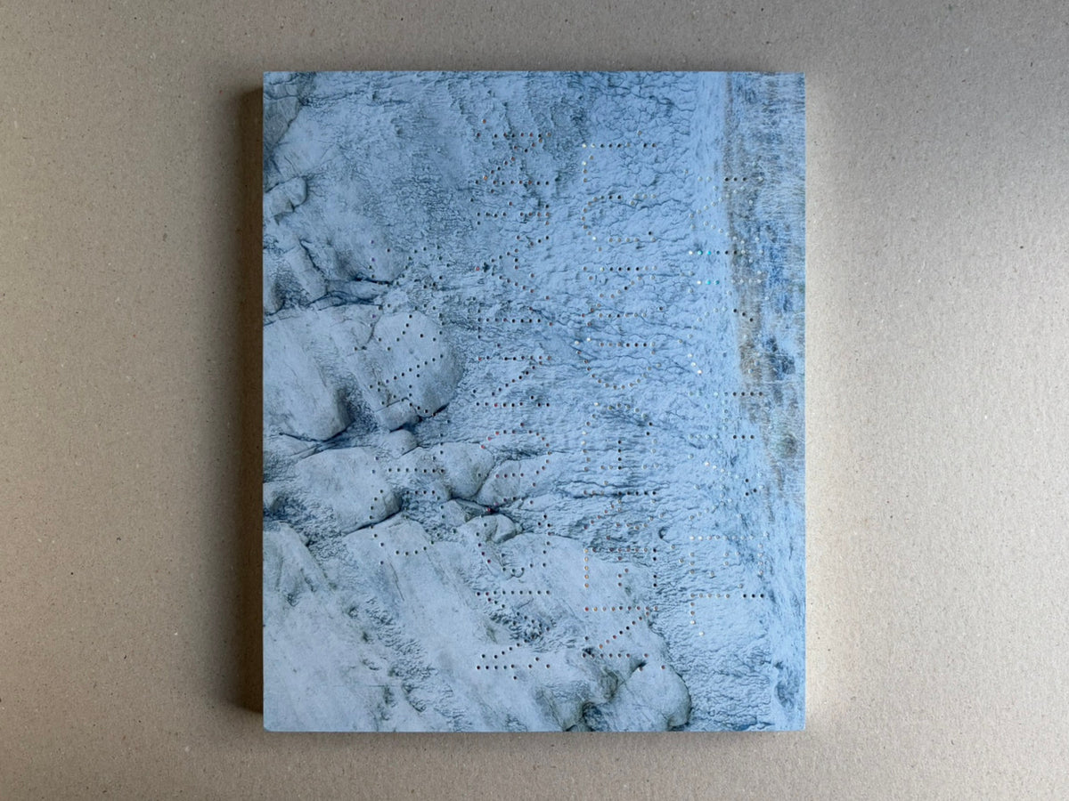 Glass Mountain by Michael Lundgren, open book page showing a blue-toned rock surface with small perforations