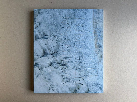Glass Mountain by Michael Lundgren, open book page showing a blue-toned rock surface with small perforations