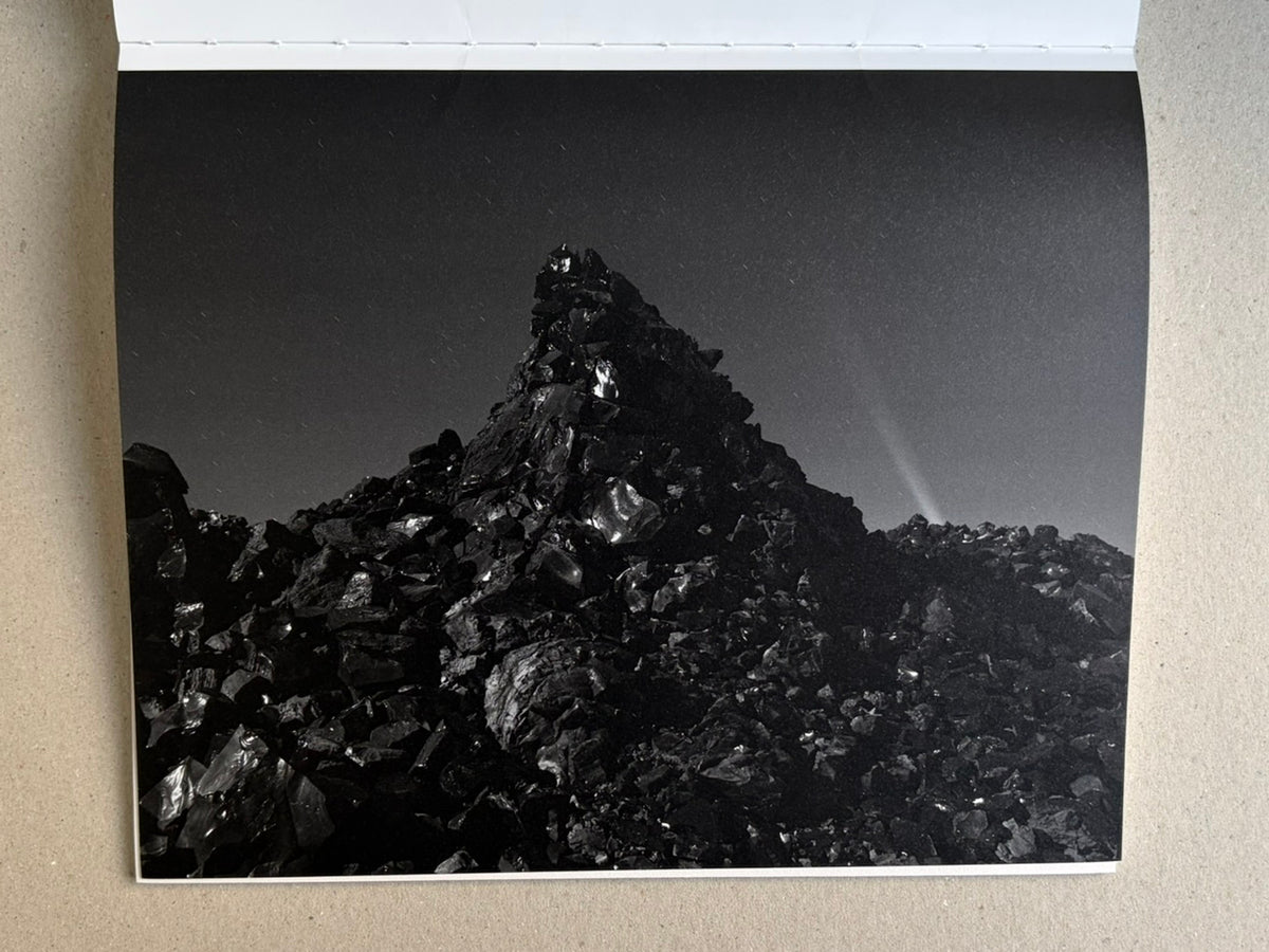 Glass Mountain by Michael Lundgren, open book page showing a black rock mound under a dim sky