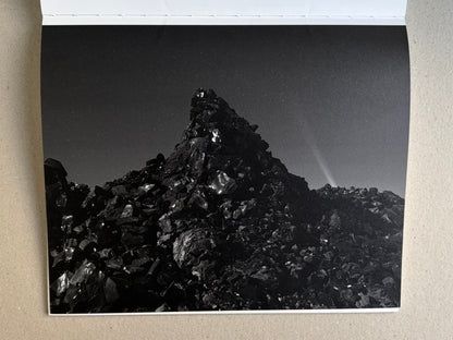 Glass Mountain by Michael Lundgren, open book page showing a black rock mound under a dim sky