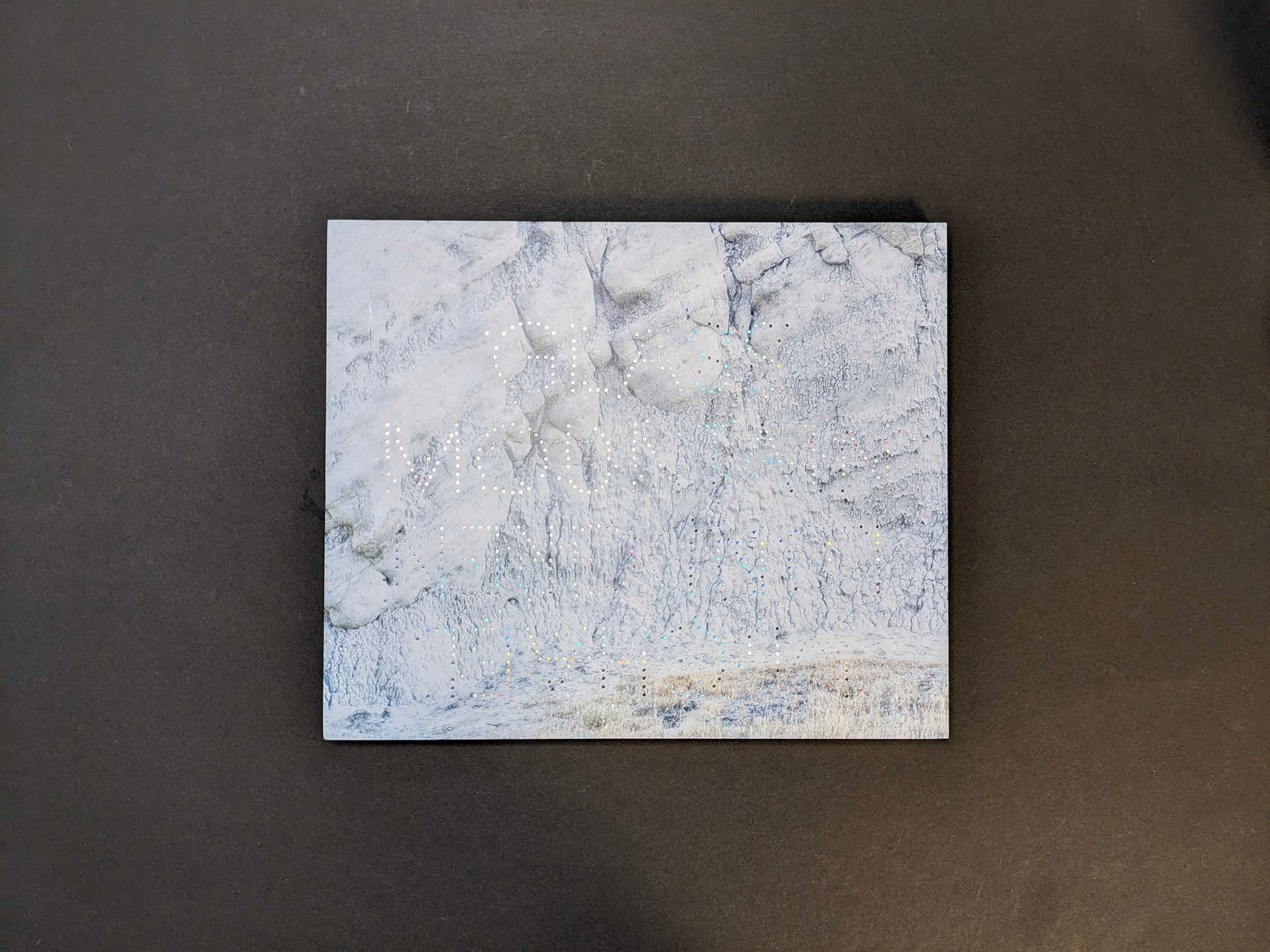 Front cover of Glass Mountain by Michael Lundgren, with a rock surface and dotted foil title