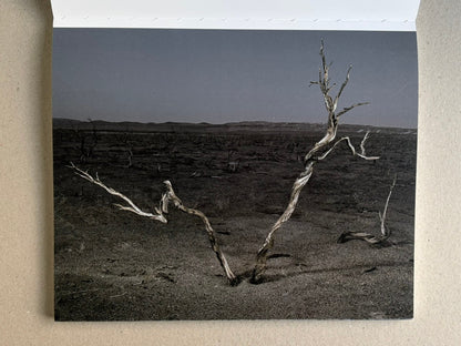 Glass Mountain by Michael Lundgren, open book page showing a pale stone ledge above a dark valley