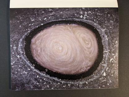 Interior photograph from Glass Mountain by Michael Lundgren showing a circular pool in rock with swirling water