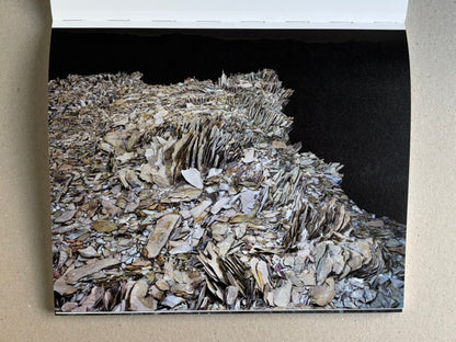 Glass Mountain by Michael Lundgren, open book page showing a layered rock formation against a black background