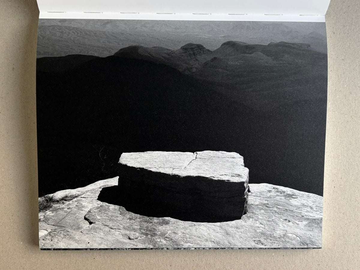 Glass Mountain by Michael Lundgren, open book page showing a flat stone slab in a wide landscape