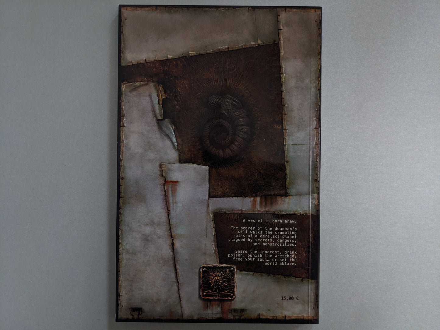 Back cover of Godhusk – Rebirth by Plastiboo, with a lore excerpt and symbolic emblem