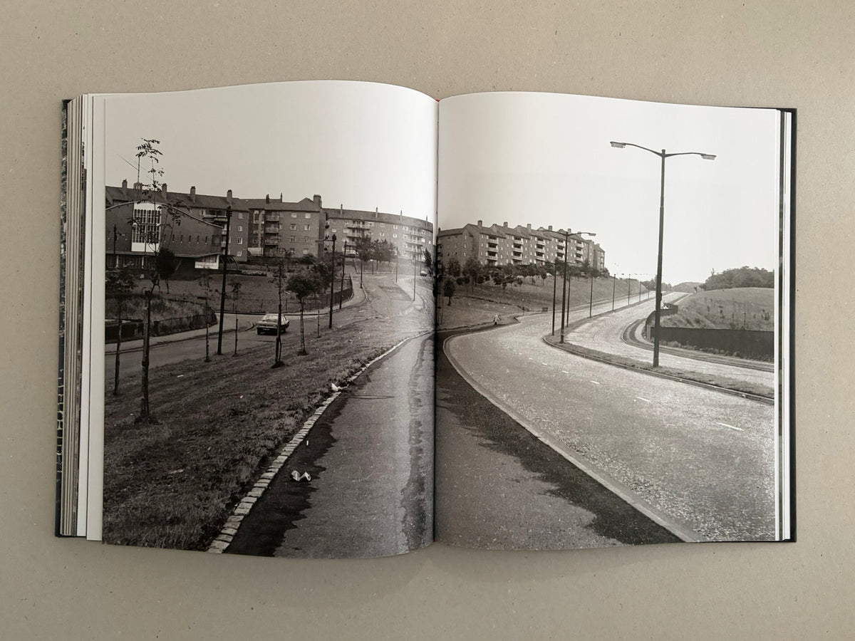 Open spread from Gorbals – Peter Christopherson showing a black-and-white street scene with apartment blocks, lampposts, and a curving road.