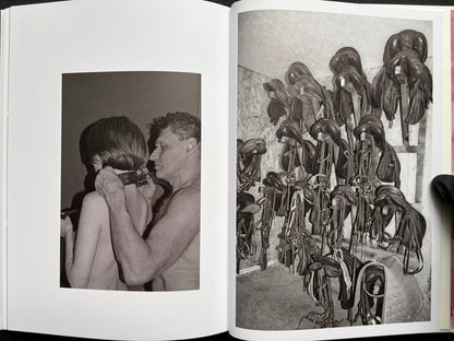 Gut Feeling by Kristina Rozhkova, open spread with a person in bondage and a wall of saddles