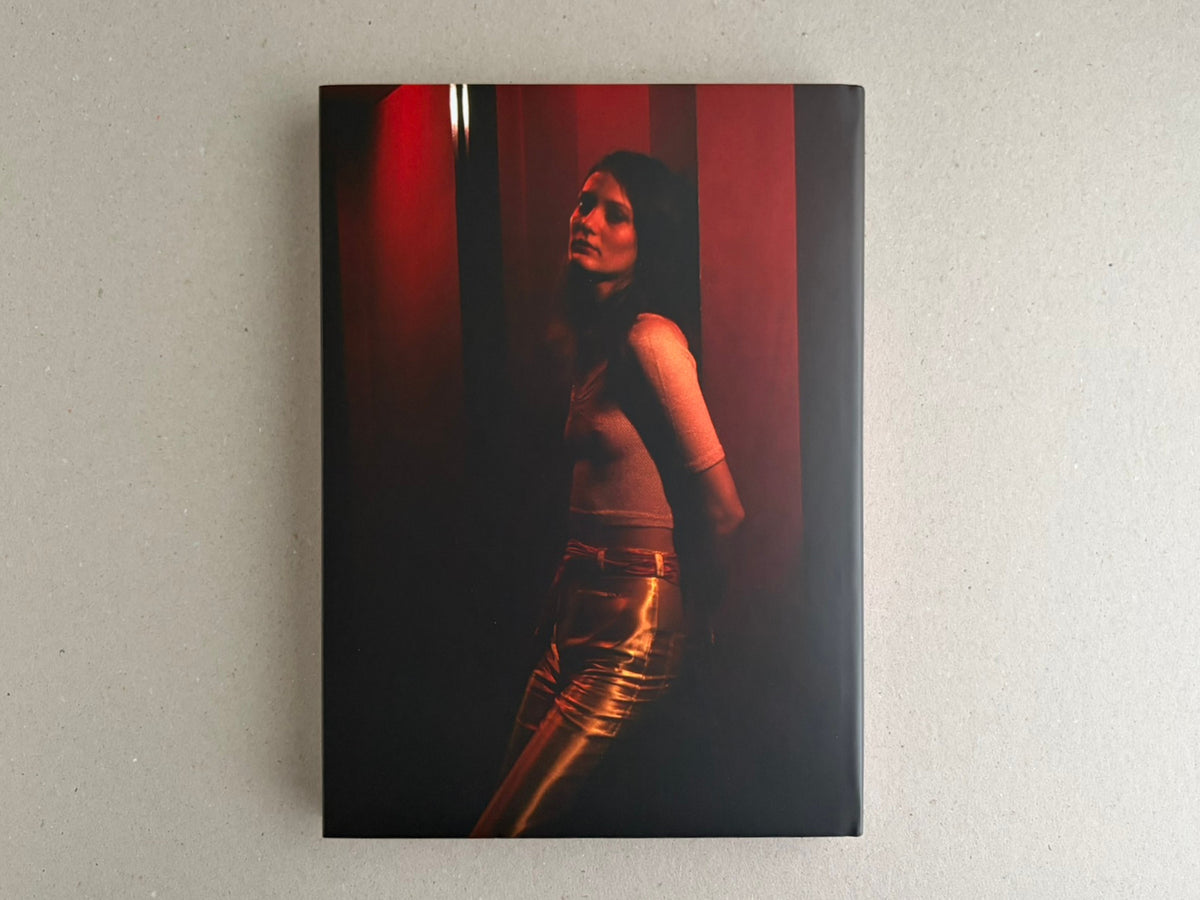 Dust jacket for HARDCORE by Eric Kroll, showing a red-lit portrait of a woman against a dark background.