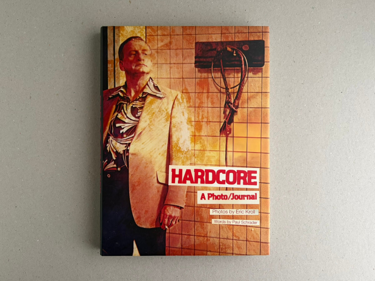 Front cover of HARDCORE: A Photo/Journal by Eric Kroll, with a man standing against a tiled wall.