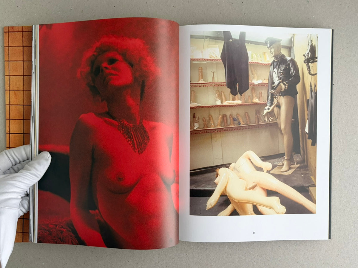 Open spread from HARDCORE (Dust Jacket) – Eric Kroll, showing a red-lit portrait on the left and a shop interior with mannequins on the right.