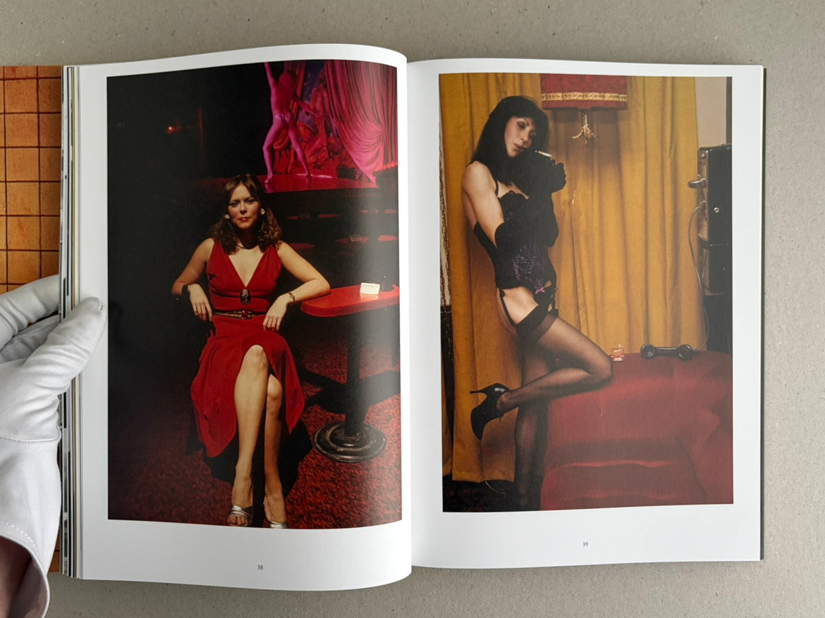 Open spread from HARDCORE by Eric Kroll, showing two colour photographs of women posed in a nightclub-like interior.
