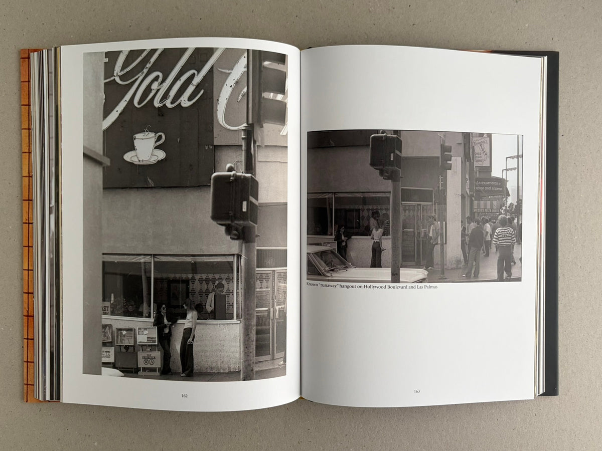 Open spread of HARDCORE (Dust Jacket) – Eric Kroll showing two black-and-white street photographs on pages 162–163.