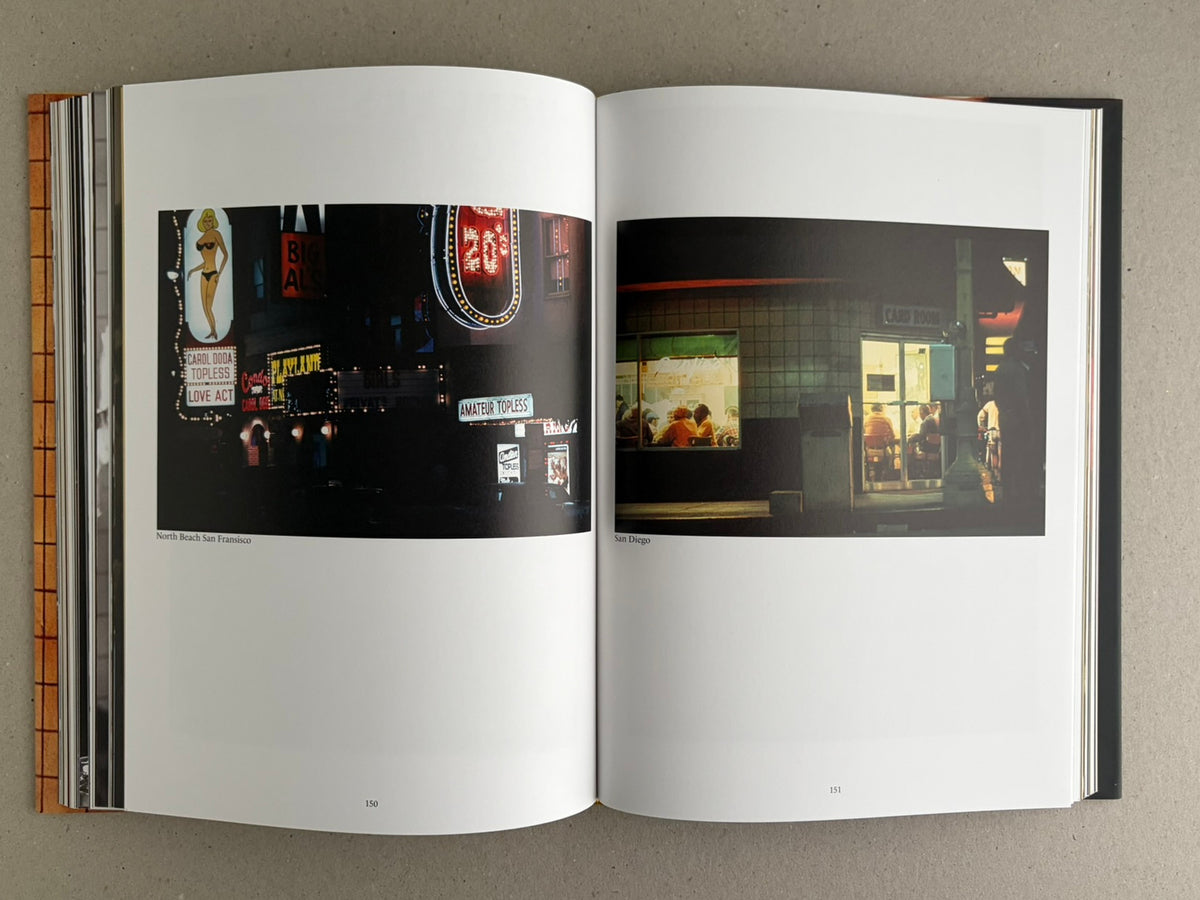 Open spread from HARDCORE by Eric Kroll showing two nighttime photographs: neon signage on the left and a lit storefront interior on the right.
