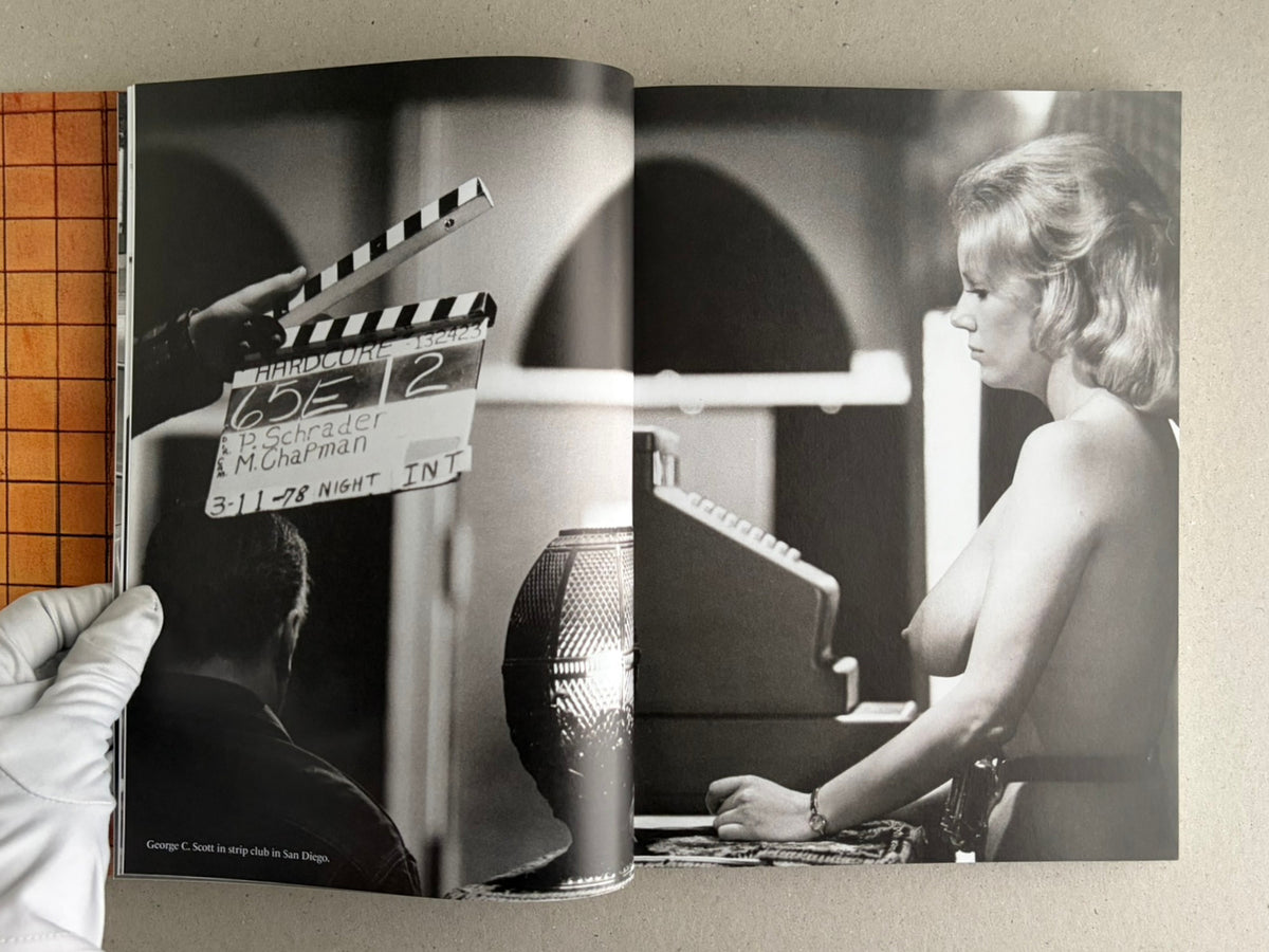 Open spread of HARDCORE (Dust Jacket) – Eric Kroll, showing a black-and-white film set photograph with a clapperboard and a nude woman in profile.