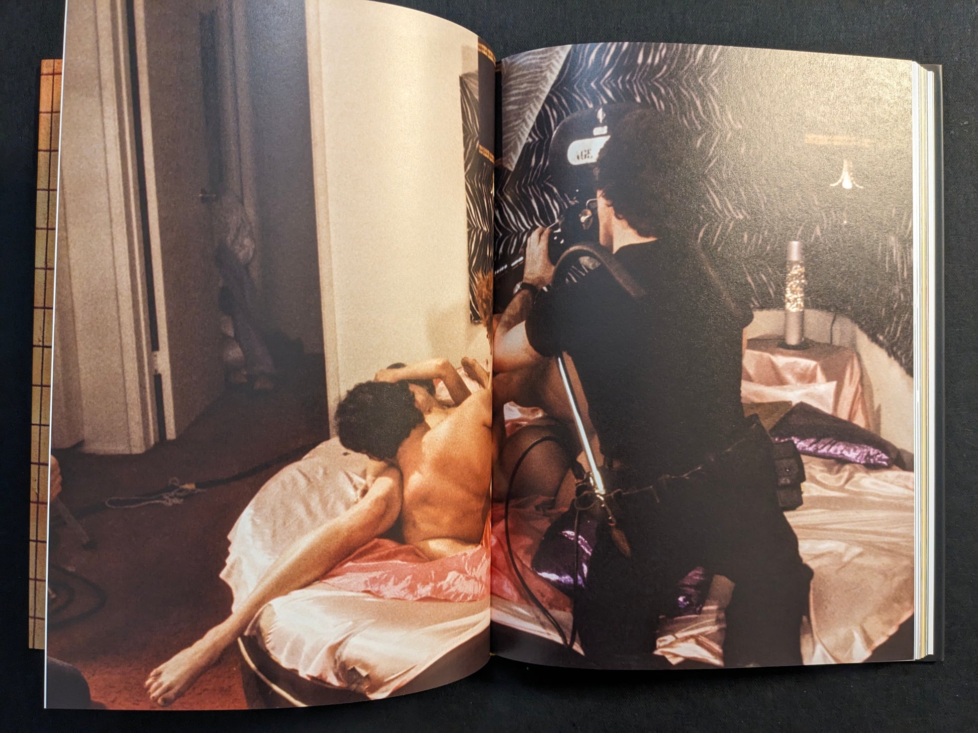 Interior spread showing explicit adult content on a film set being photographed, from “HARDCORE (dust jacket)” by Eric Kroll.