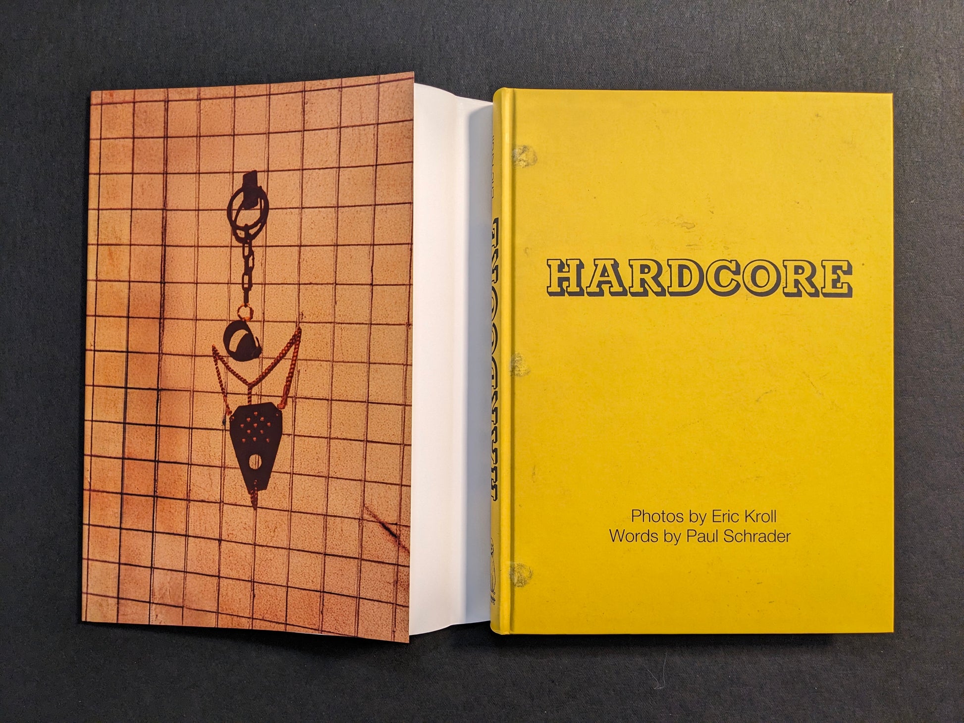 Book shown with dust jacket removed, revealing the yellow cloth cover of “HARDCORE” and the printed dust jacket.
