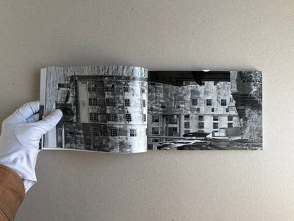 Open spread of Hashima by Taiji Matsue, showing a black-and-white photograph of an abandoned building on the page.