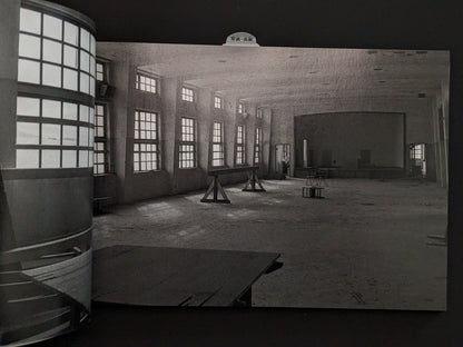 Interior view of an empty hall with windows in the ruins of Hashima Island