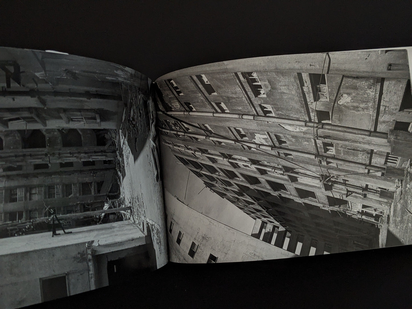 Photograph of decaying apartment buildings on Hashima Island, showing collapsing walls and empty windows