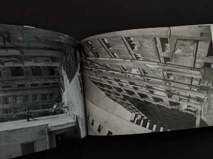 Photograph of decaying apartment buildings on Hashima Island, showing collapsing walls and empty windows