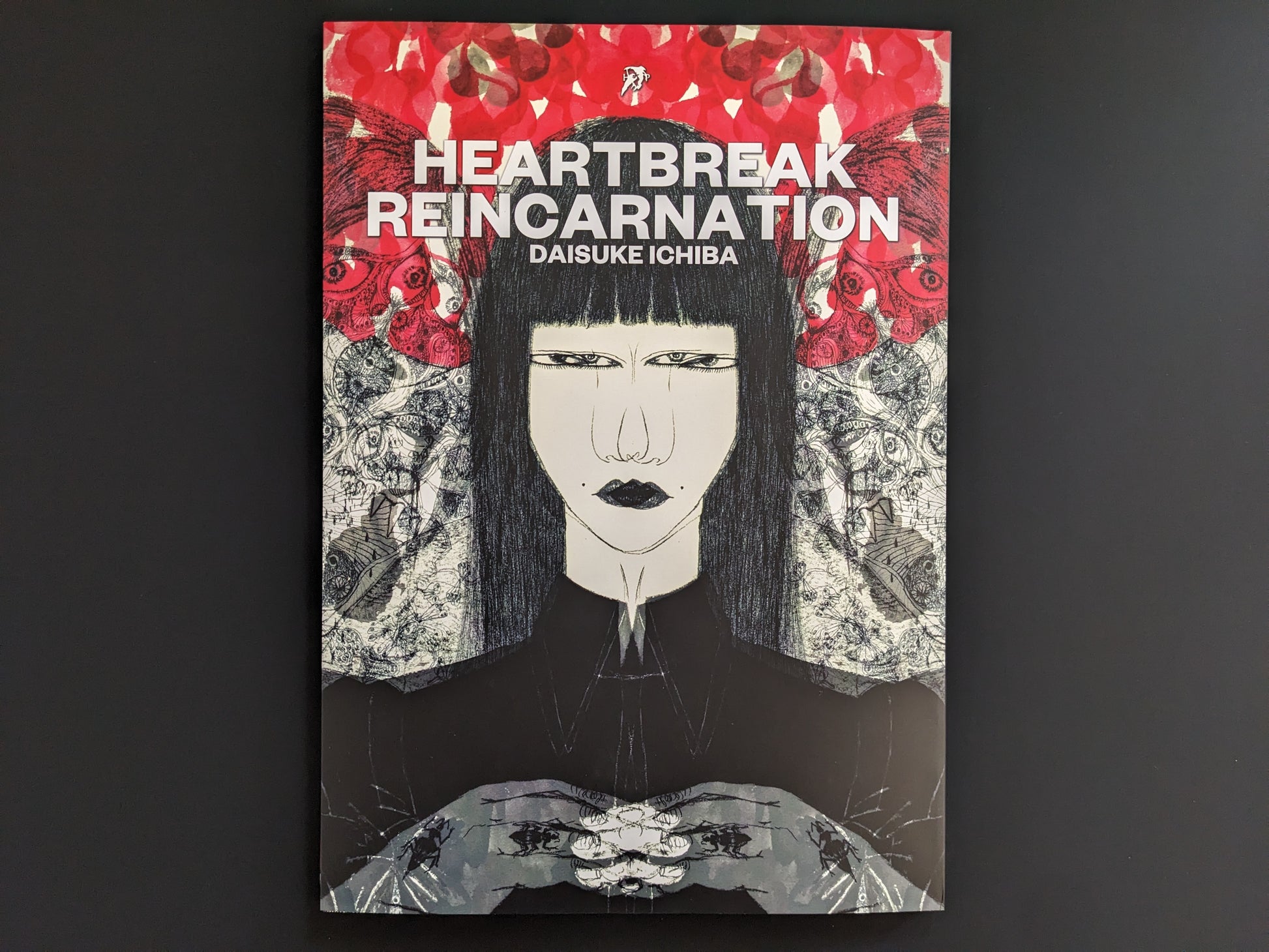 Book cover of 'Heartbreak Reincarnation' by Daisuke Ichiba with a stylized illustration of a woman against a red and black background.