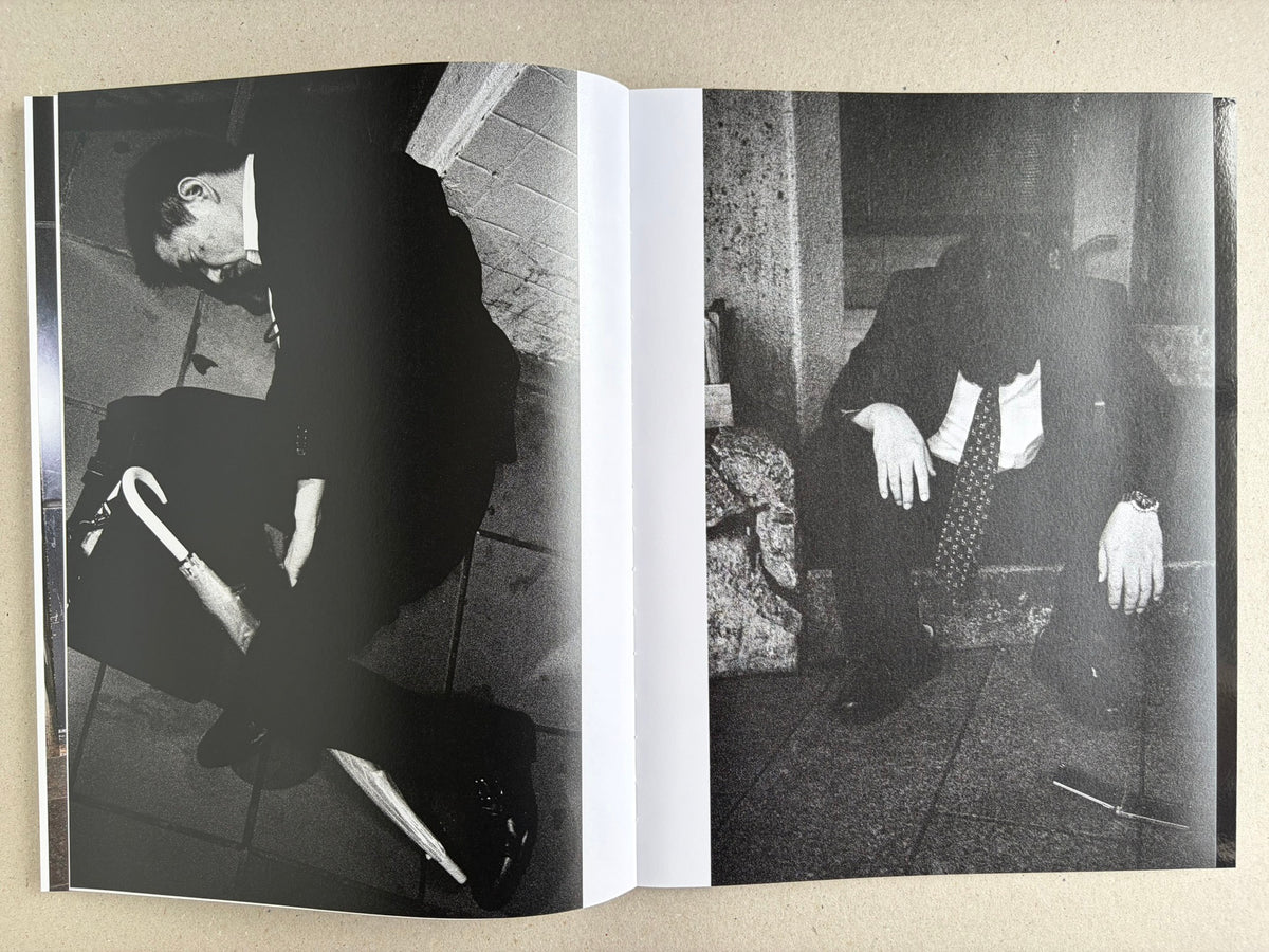 Black-and-white interior spread with two suited men collapsed on the ground in separate photographs.