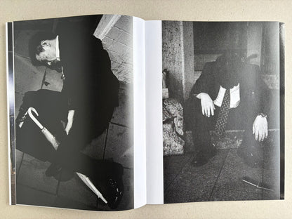 Black-and-white interior spread with two suited men collapsed on the ground in separate photographs.