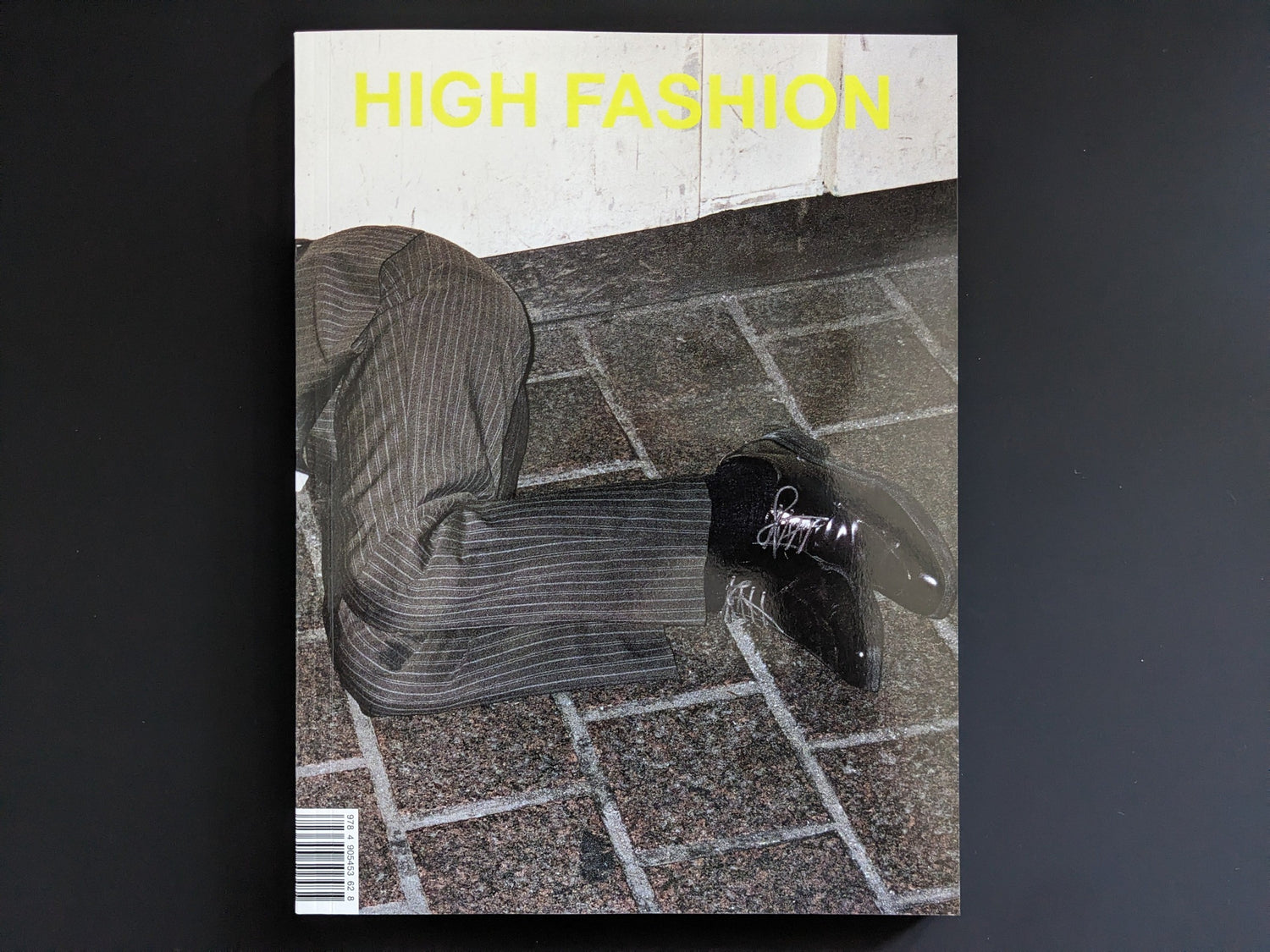 Front cover of High Fashion by Pawel Jaszczuk, with yellow title text and a cropped figure on tiled pavement