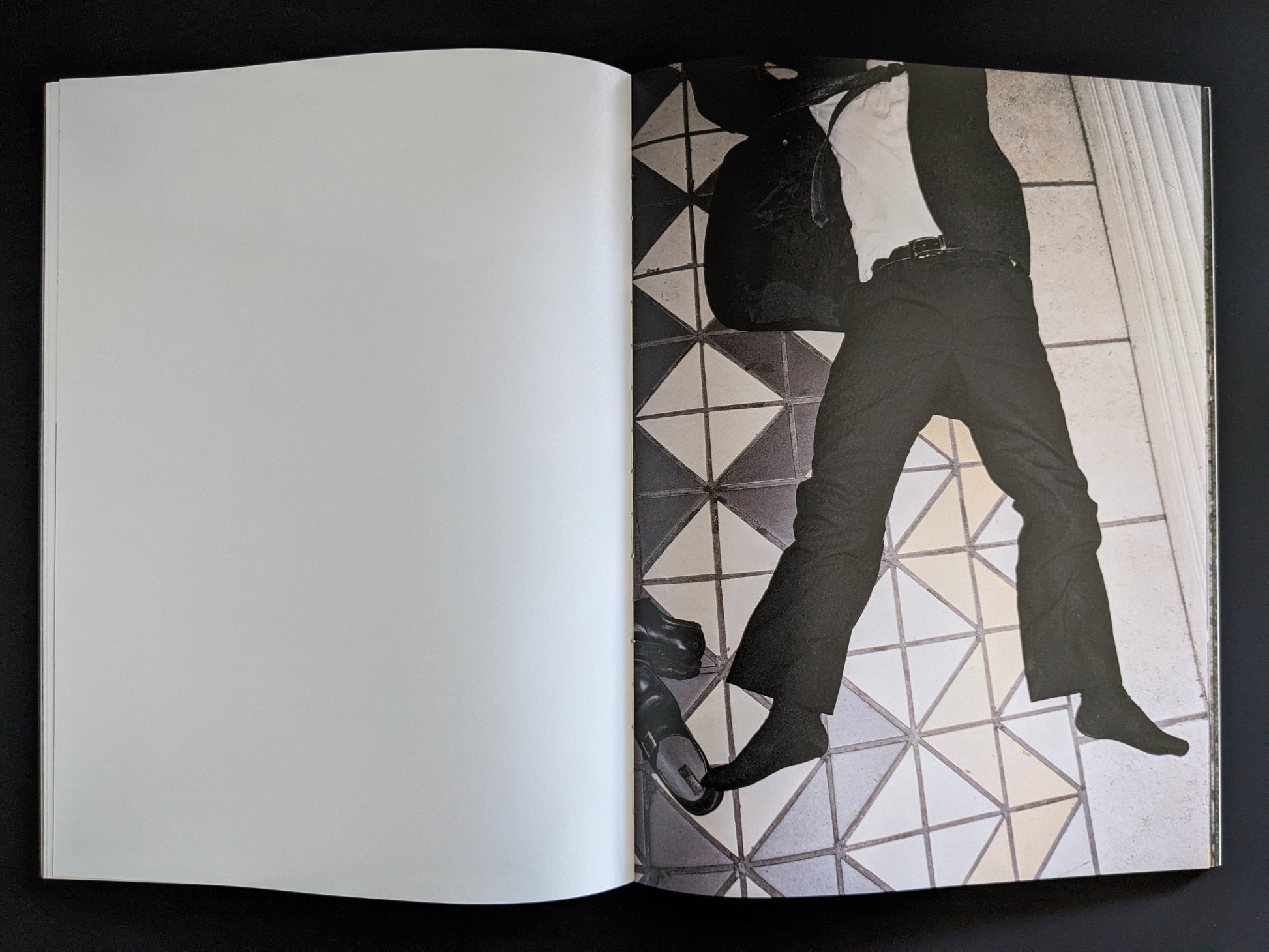 Open spread showing the legs of a passed-out salaryman on a tiled floor