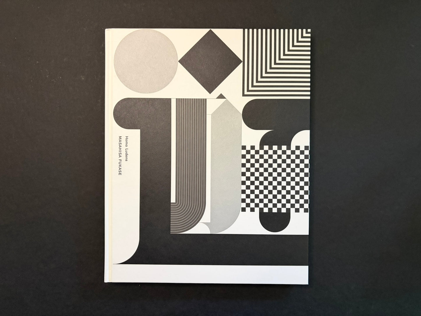 Homo Ludens by Masahisa Fukase, front cover with black, white, and grey geometric design