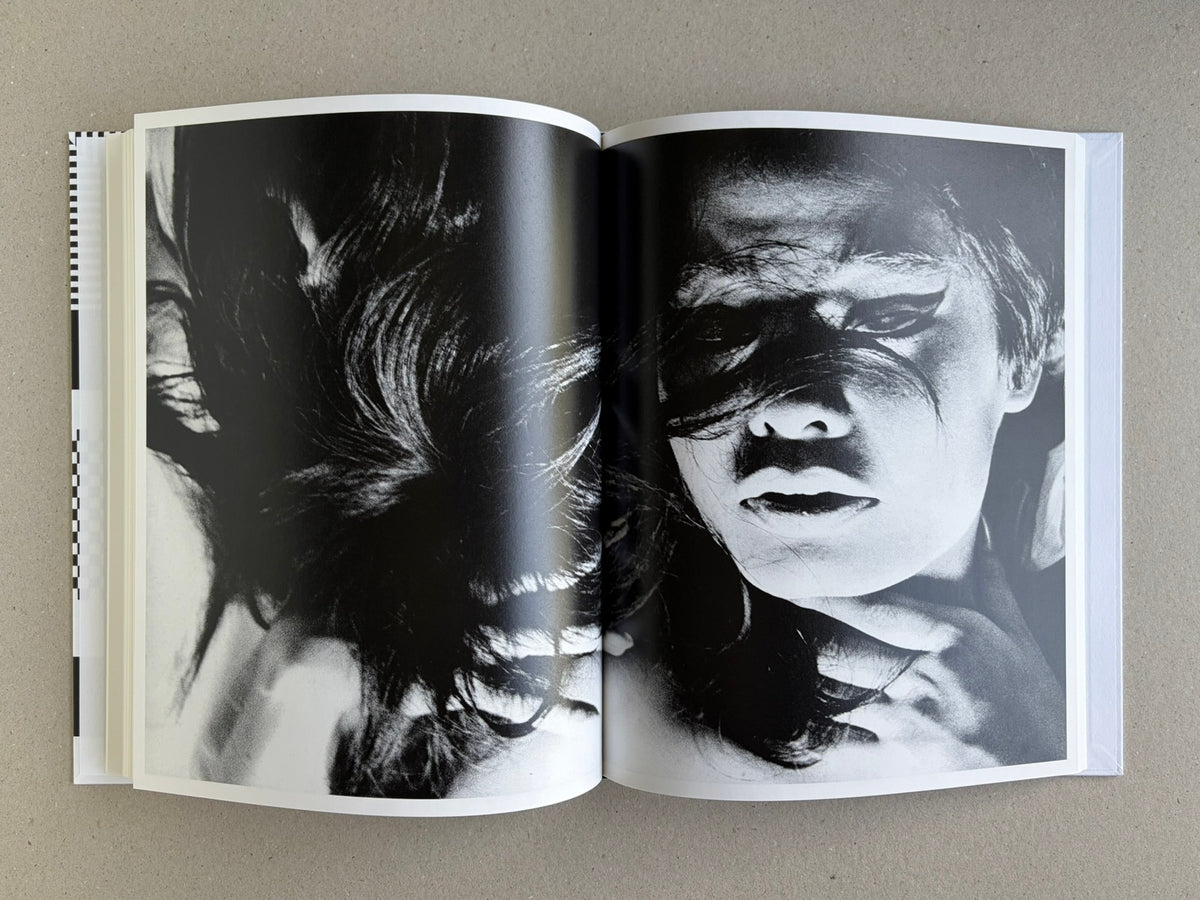 Homo Ludens open to a spread with a black-and-white portrait