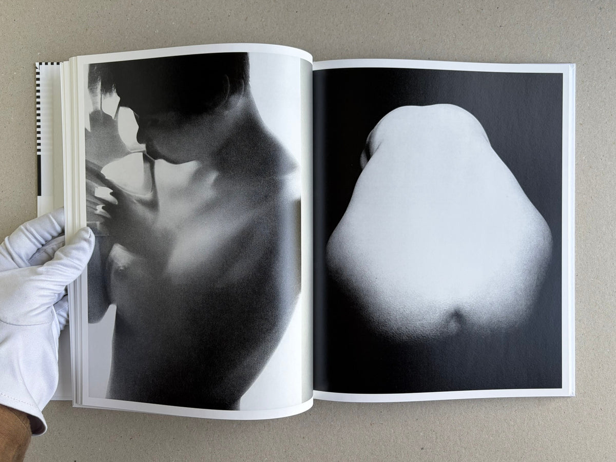 Homo Ludens open to a spread with abstract black-and-white nude forms