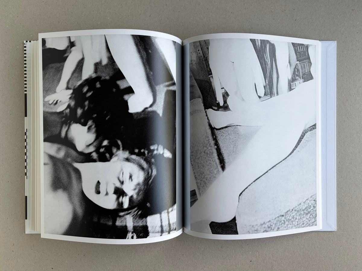 Homo Ludens open to a spread with blurred black-and-white figure studies