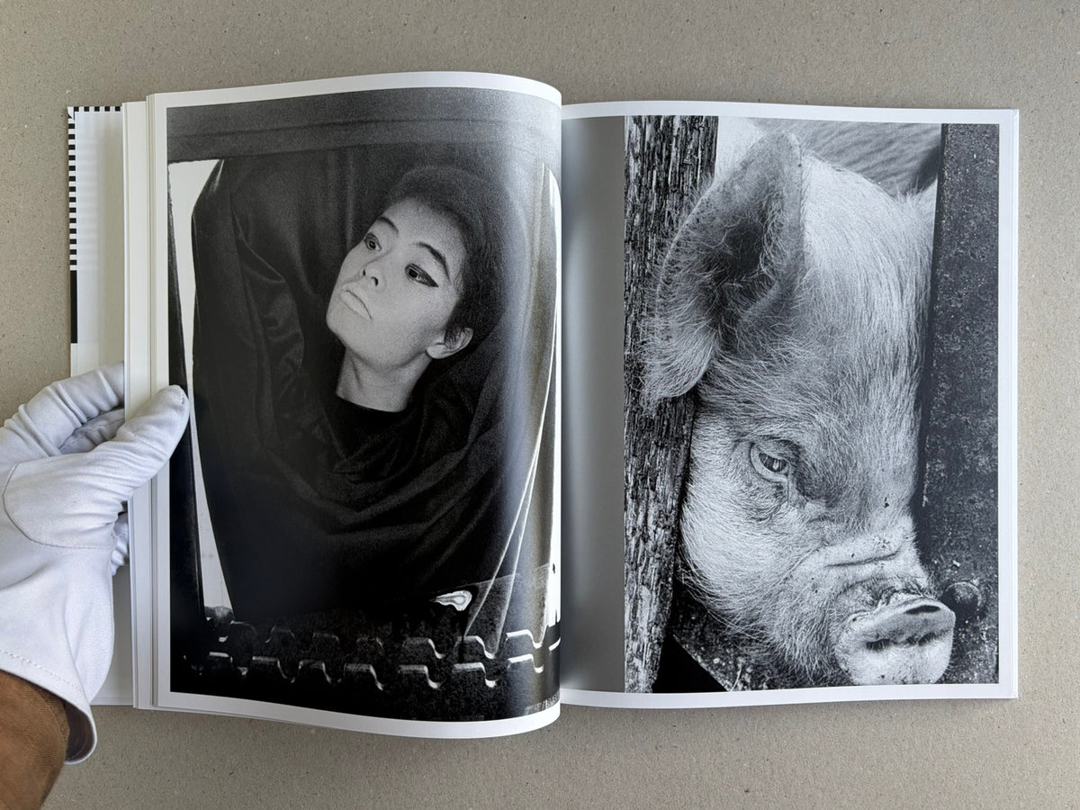 Homo Ludens open to a spread with black-and-white photographs, including a portrait and an animal close-up
